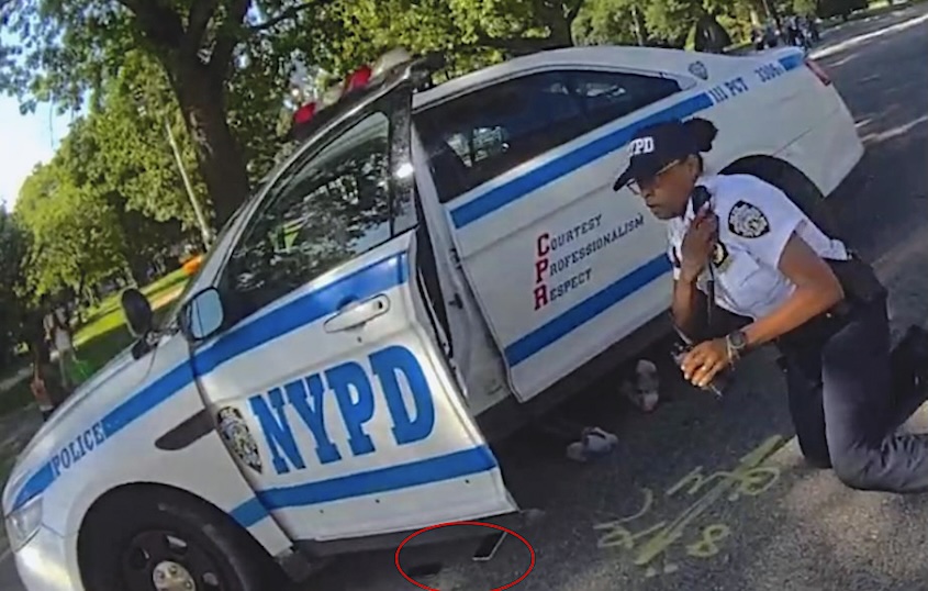 Still from Officer Devone’s BWC showing Mr. Huerta Gonzalez’s feet sticking out from under the police car.